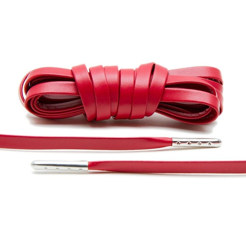 May include: Red leather shoelaces with silver metal aglets.