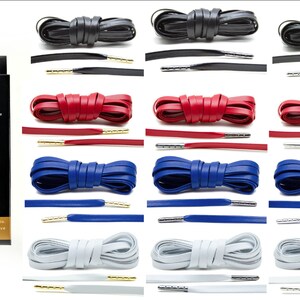 May include: A set of 10 pairs of leather shoelaces in black, red, blue, and white. Each pair has metal tips and comes in a box labeled "BRAVURA&trade; Luxury Authentic Leather Laces".