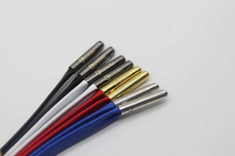 May include: A set of six speaker wire banana plugs with different colored jackets. The plugs are labeled "Banana Plug" and are made of metal.