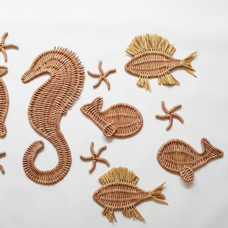 May include: A set of woven wicker sea creature wall decor, including a seahorse, starfish, and fish. The decor is made of natural materials and has a rustic, coastal feel.