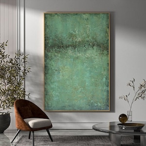 May include: Abstract painting with a textured green and blue colour scheme. The painting is framed in a gold frame and is hanging on a white wall.