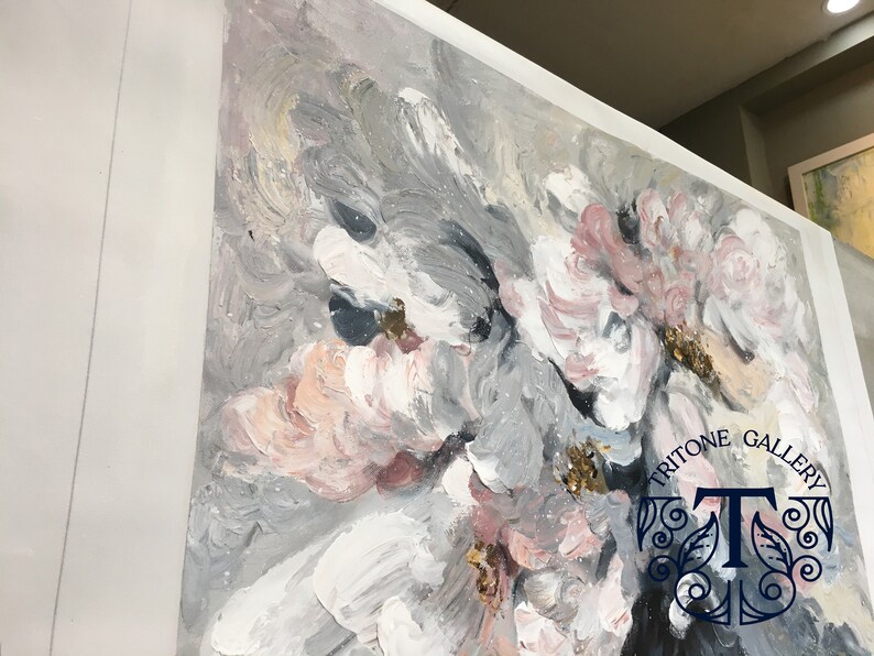 May include: Abstract painting with pink, white, and gray flowers. The painting has a textured, brushstroke effect. The bottom right corner of the painting has the text "Tritone Gallery" and a stylized "T".