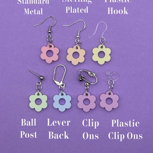 May include: A selection of flower-shaped earrings in various colors, including pink, yellow, and blue, with different earring back styles. The image shows options like standard metal hooks, sterling plated, plastic hooks, ball posts, lever backs, clip-ons, and plastic clip-ons.