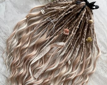 May include: A set of brown and blonde synthetic dreadlocks with various embellishments, including seashells, flowers, and lace. The dreadlocks are tied together with a black ribbon.