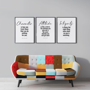May include: Three framed inspirational quotes on a white wall. The quotes are "Character is how you treat those that can do nothing for you." by John Maxwell, "Attitude is like a mirror. The attitude you give out is the same attitude you will get back." by John Maxwell, and "Integrity is doing the right thing even when no one is watching." by C.S. Lewis.