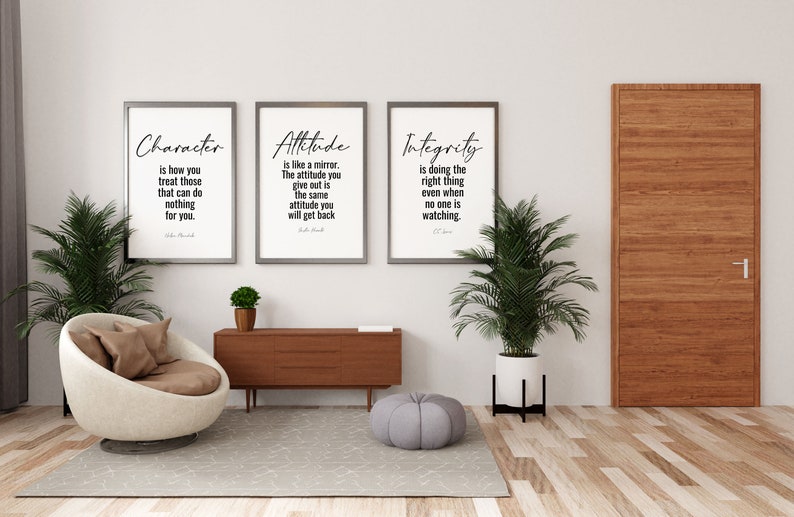 May include: Three framed inspirational quotes on a white wall with a brown door, a brown armchair, a wooden table, and two potted plants. The quotes are "Character is how you treat those that can do nothing for you." "Attitude is like a mirror. The attitude you give out is the same attitude you will get back." "Integrity is doing the right thing even when no one is watching."