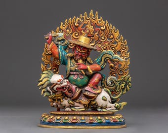 May include: A detailed, colorful statue depicting a deity with a red face and hat, riding a white and gold mythical creature. The figure is surrounded by a golden flame-like design. The base of the statue is multi-colored.