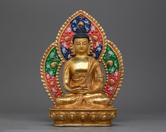 May include: A gold-coloured Buddha statue with a colourful halo, sitting in a meditative pose with hands in the Dhyana mudra. The statue is on a lotus base.