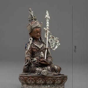 May include: A small, ornate bronze statue of a seated figure with a silver crown and scepter. The statue is 9 inches wide and 17 inches tall.
