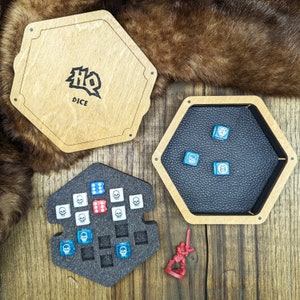 May include: A wooden box with a hexagonal lid and the text "HQ Dice" on the top. The box is open and contains a set of dice with skull and crossbones designs. The box is sitting on a wooden surface.