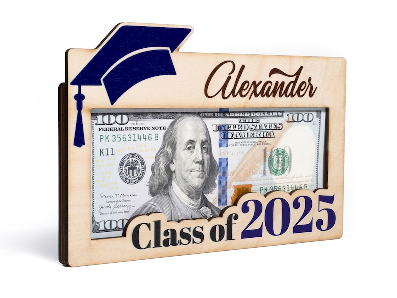 May include: A wooden frame with a graduation cap design, a dollar bill inside, and the text "Alexander Class of 2025".
