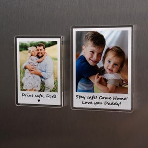 May include: Two rectangular photo magnets with family photos and text. One shows a man and child with the text "Drive safe, Dad!". The other shows two children with the text "Stay safe! Come Home! Love you Daddy!"