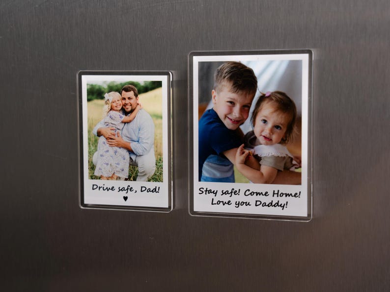 May include: Two rectangular photo magnets with family photos and text. One shows a man and child with the text "Drive safe, Dad!". The other shows two children with the text "Stay safe! Come Home! Love you Daddy!"