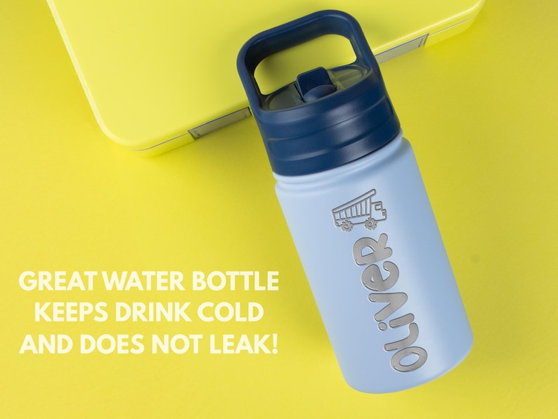 May include: A light blue water bottle with a dark blue lid and handle. The bottle features a graphic of a dump truck and the name Oliver in silver lettering. The text GREAT WATER BOTTLE KEEPS DRINK COLD AND DOES NOT LEAK! is visible.