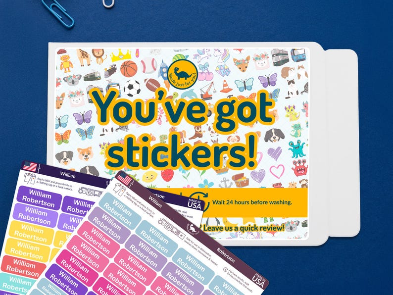 May include: A set of personalized name stickers with a variety of colorful designs and the text "You've got stickers!". The stickers are in various colors and feature the name "William Robertson". The background is a blue surface.