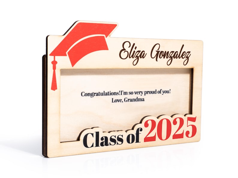May include: Wooden picture frame with a graduation cap design. The frame has a space for a photo and a message. The message reads "Congratulations! I'm so very proud of you! Love, Grandma". The frame also has the text "Eliza Gonzalez" and "Class of 2025".