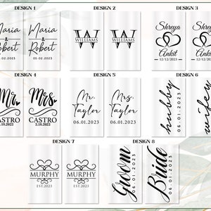 May include: Eight different designs for wedding or engagement toasts. Each design features a different font style and layout with the names of the couple and the date of their wedding or engagement. The designs are printed on a clear background.