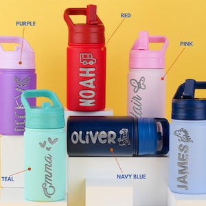 May include: Six water bottles with carrying handles and straws in purple, red, pink, teal, navy blue, and sky blue. Each bottle features a unique name and graphic, including Noah, Emma, Oliver, and James, with color labels pointing to each.