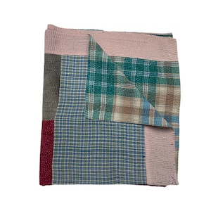 May include: A patchwork quilt featuring a mix of colours and patterns, including pink, green, blue, and brown. The quilt is made from squares of different fabrics, with visible seams.