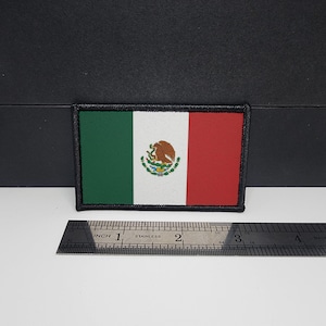 May include: Rectangular embroidered patch featuring the Mexican flag. The flag design includes vertical stripes of green, white, and red, with the Mexican coat of arms in the center. The patch is approximately 3 inches wide.