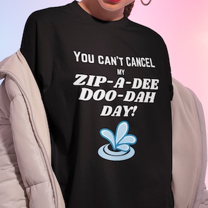 May include: Black t-shirt with white text that reads "You can't cancel my zip-a-dee-doo-dah day!" and a blue water drop graphic.