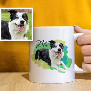 May include: White ceramic mug featuring a watercolour illustration of a black and white border collie dog with blue eyes. The dog's name "Blu" is written in cursive on the mug.