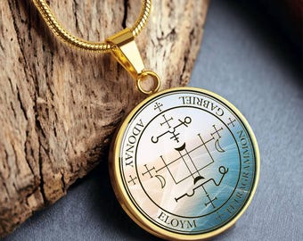 May include: Gold chain necklace with a round pendant featuring a sigil with the words "Gabriel", "Adonai", "Elohim", and "Tetragrammon" inscribed around the perimeter.