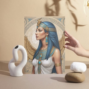 May include: A digital illustration of a woman with blue hair and a gold crown, wearing a white dress with gold and blue jewelry. She has wings and is set against a background of gold and blue geometric patterns.