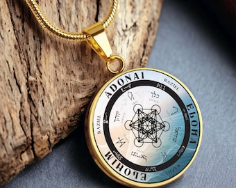 May include: A gold necklace with a round pendant featuring a geometric design and Hebrew text. The pendant has a blue and white background with black text. The text on the pendant reads "ADONAI ELOHIM" and includes the names of angels.