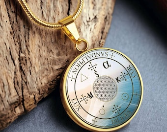 May include: Gold necklace with a round pendant featuring a white and blue design with the text "SANDALPHON", "LUX", "DILIGES", "COR", "K", "S", "M", "α", and a flower of life symbol.