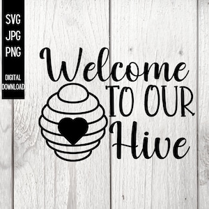May include: Black and white digital download design with the text "Welcome TO OUR Hive" and a beehive graphic with a heart. The design is on a white wooden background. Includes SVG, JPG, and PNG file formats.