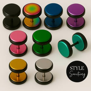 May include: A selection of double-sided ear gauges in a range of colours: black, rainbow, blue, purple, pink, green, gold, and silver. Each gauge features a black border and a central disc.