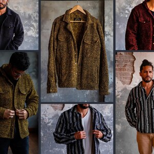May include: Collection of textured button-down shirts in various colors. Includes a black, olive green, and burgundy jacket, and a striped shirt. One shirt is displayed on a wooden hanger. The shirts have a casual, rugged style.