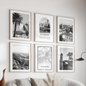 May include: A set of six framed black and white art prints. The prints feature architectural and landscape photography, including a palm tree, cityscapes, and a map. The text "Riverside" is visible on two prints. The set is displayed in a living room setting.