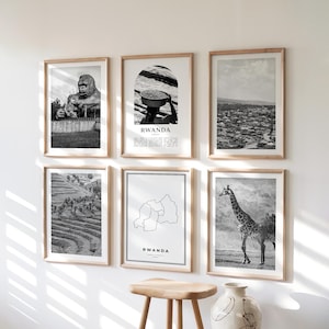 May include: A collection of six framed monochrome prints in wooden frames. The prints feature a gorilla, a person with a basket, a cityscape, terraced fields, a map of Rwanda, and a giraffe. The word "RWANDA" is printed on two of the prints.
