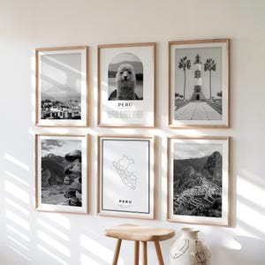 May include: A set of six framed monochrome prints. The prints depict landscapes, architecture, and a map of Peru. The prints are displayed on a white wall. The frames are made of light-coloured wood.