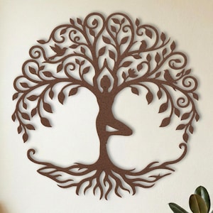 Tree pose metal wall art, yoga studio decor with rolled mats.