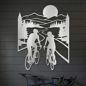 Silver road biking metal art, cycling couple decor in modern mudroom above bicycles