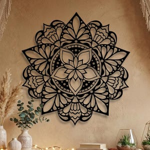 Black metal mandala wall art, boho eclectic living room decor with dried pampas grass.