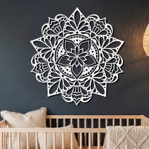 White floral mandala wall hanging, boho nursery decor above crib.
