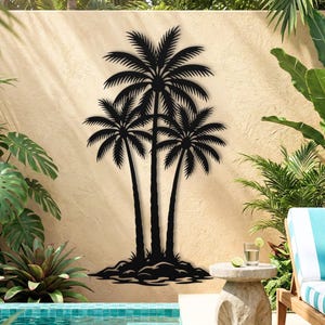 May include: Black metal palm tree wall art. The artwork features three palm trees with detailed fronds and trunks. The text at the bottom reads "OUTDOOR SAFE & WEATHER RESISTANT FINISH".