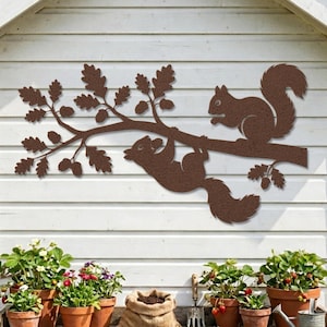 Rustic hammered copper squirrel wall art, outdoor garden shed decor with acorn branch.