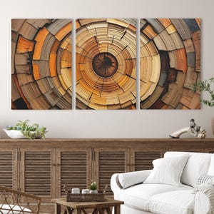 May include: A triptych of abstract art panels featuring a concentric circular design reminiscent of tree rings. The artwork showcases a range of warm, earthy tones, including browns, oranges, and yellows, creating a natural and textured appearance. The panels are mounted on a wall.