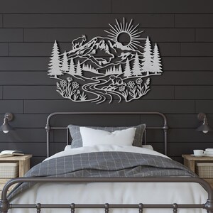 Silver laser cut steel Rainier mountain scene on dark grey shiplap wall.