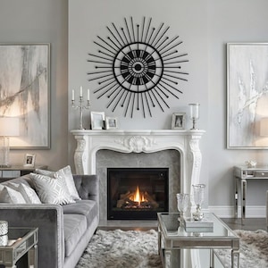 Black starburst wall decor, architectural geometric metal art over white fireplace mantle in bright living room.