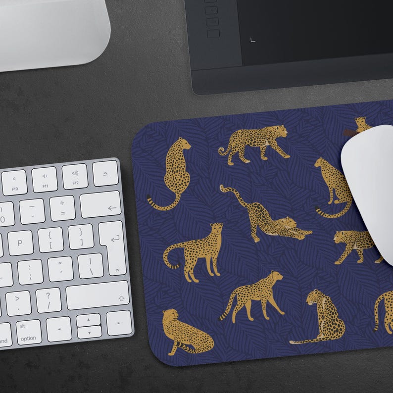 May include: A blue and gold mouse pad with a repeating pattern of leopards. The leopards are in various poses, including sitting, standing, and stretching.