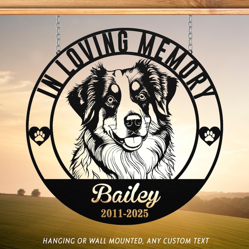 May include: Black metal memorial sign with a dog portrait, the words "IN LOVING MEMORY" and a paw print heart. The dog's name, "Bailey", and dates "2011-2025" are below the portrait. The sign hangs from chains.