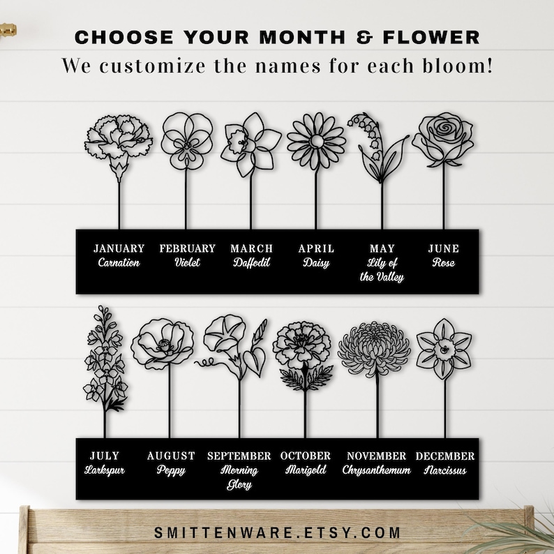 K&ouml;nnte beinhalten: Schwarze Metall-Wandkunst mit stilisierten Blumendesigns, die jeden Monat des Jahres darstellen. Jede Blume ist mit dem entsprechenden Monat und Namen beschriftet. Der Text "CHOOSE YOUR MONTH & FLOWER" steht oben.