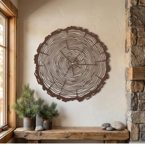 Brown hammered copper large metal tree slice wall art, earthy rustic lodge decor next to stone wall