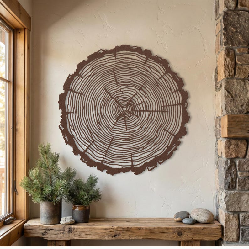 Brown hammered copper large metal tree slice wall art, earthy rustic lodge decor next to stone wall
